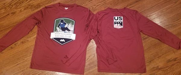 Two maroon long-sleeved shirts with ski-themed logos on a wooden surface.