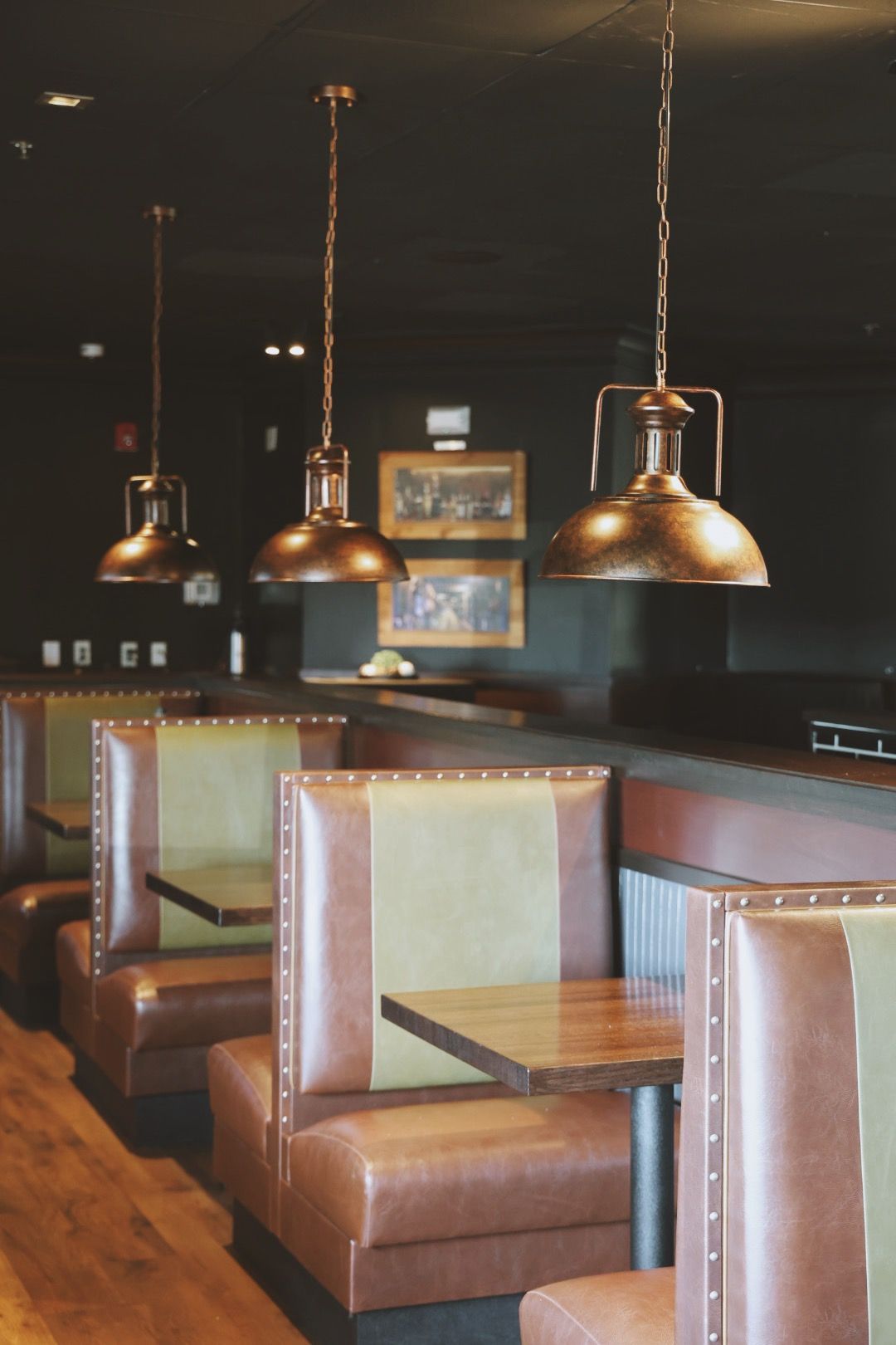A row of booths with tables in a restaurant
