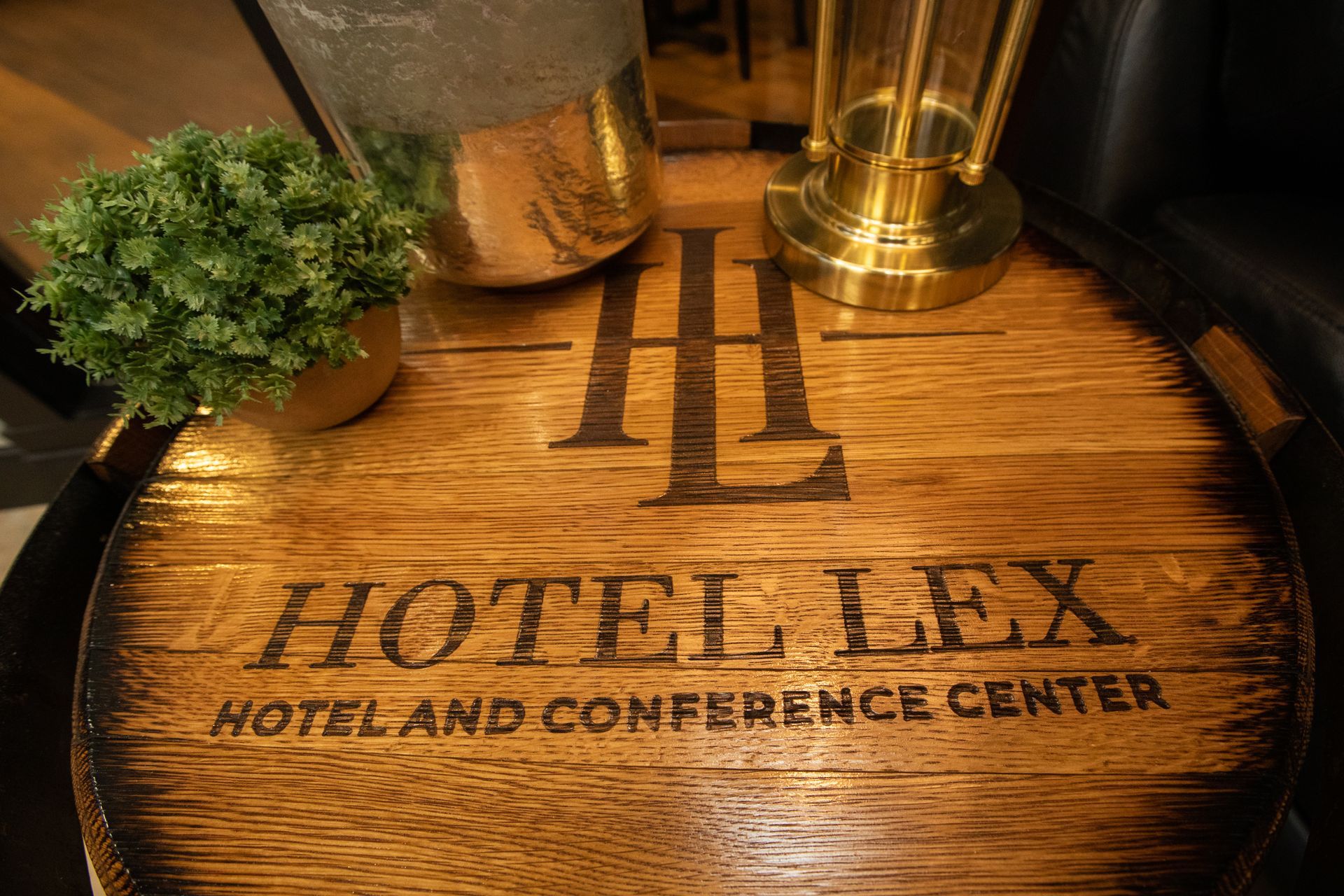 A wooden table with the hotel lex hotel and conference center written on it