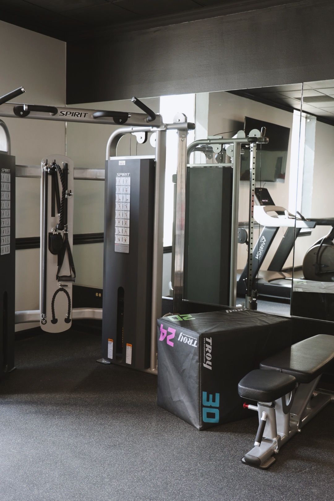 A gym with a bench and a machine with the number 30 on it