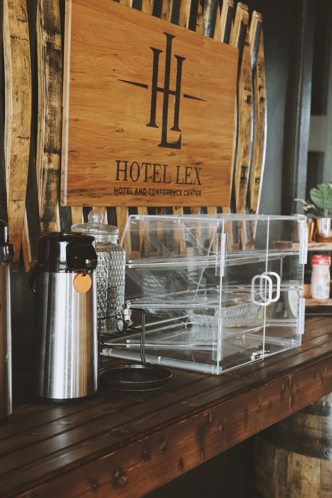 A wooden sign with the word hotel on it is on a wooden table.