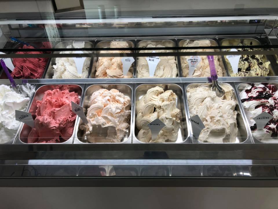 Vetrina per gelati con vari gusti di gelato colorati.