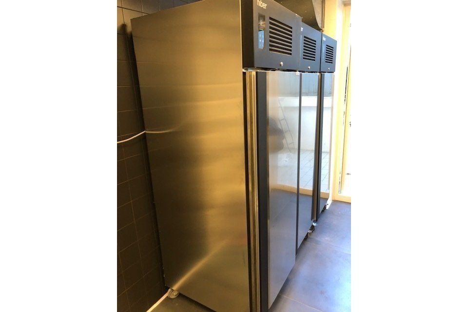 Frigoriferi commerciali in acciaio inox in fila.