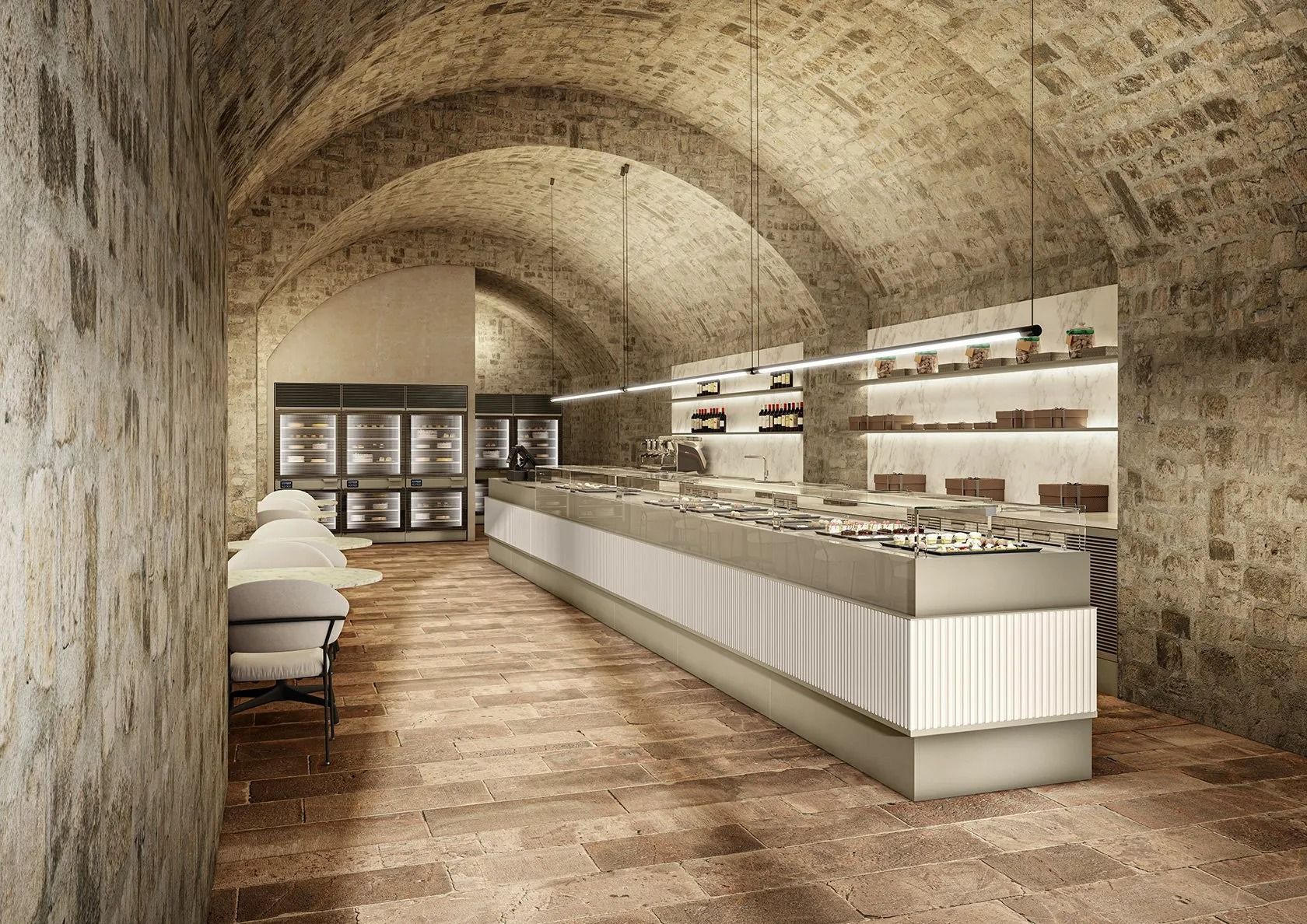 Negozio di cioccolato in una cantina con pareti in mattoni, bancone illuminato e scaffali pieni di prelibatezze.