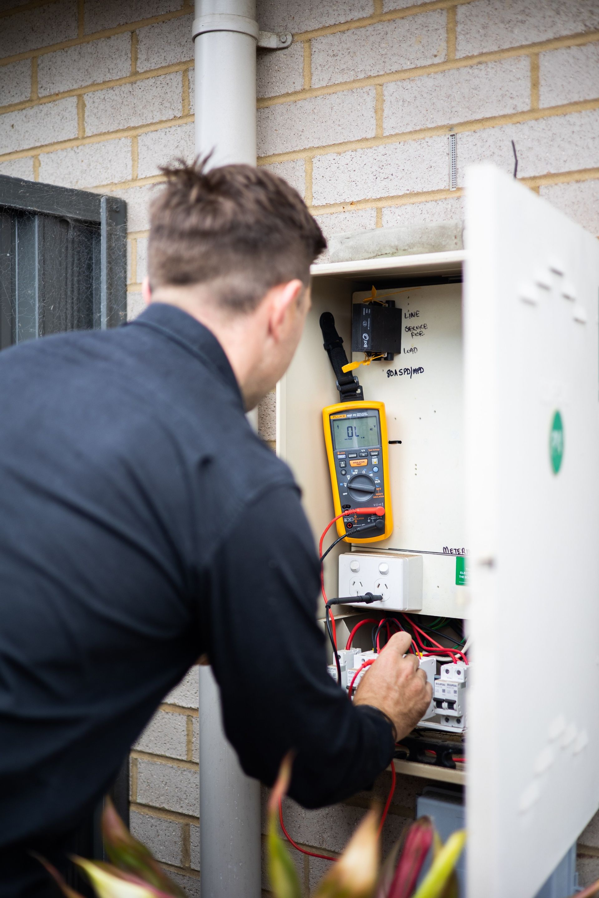 Shadow of a Worker Close to a McDonald's Sign — Level 2 Electrician in Toukley, NSW