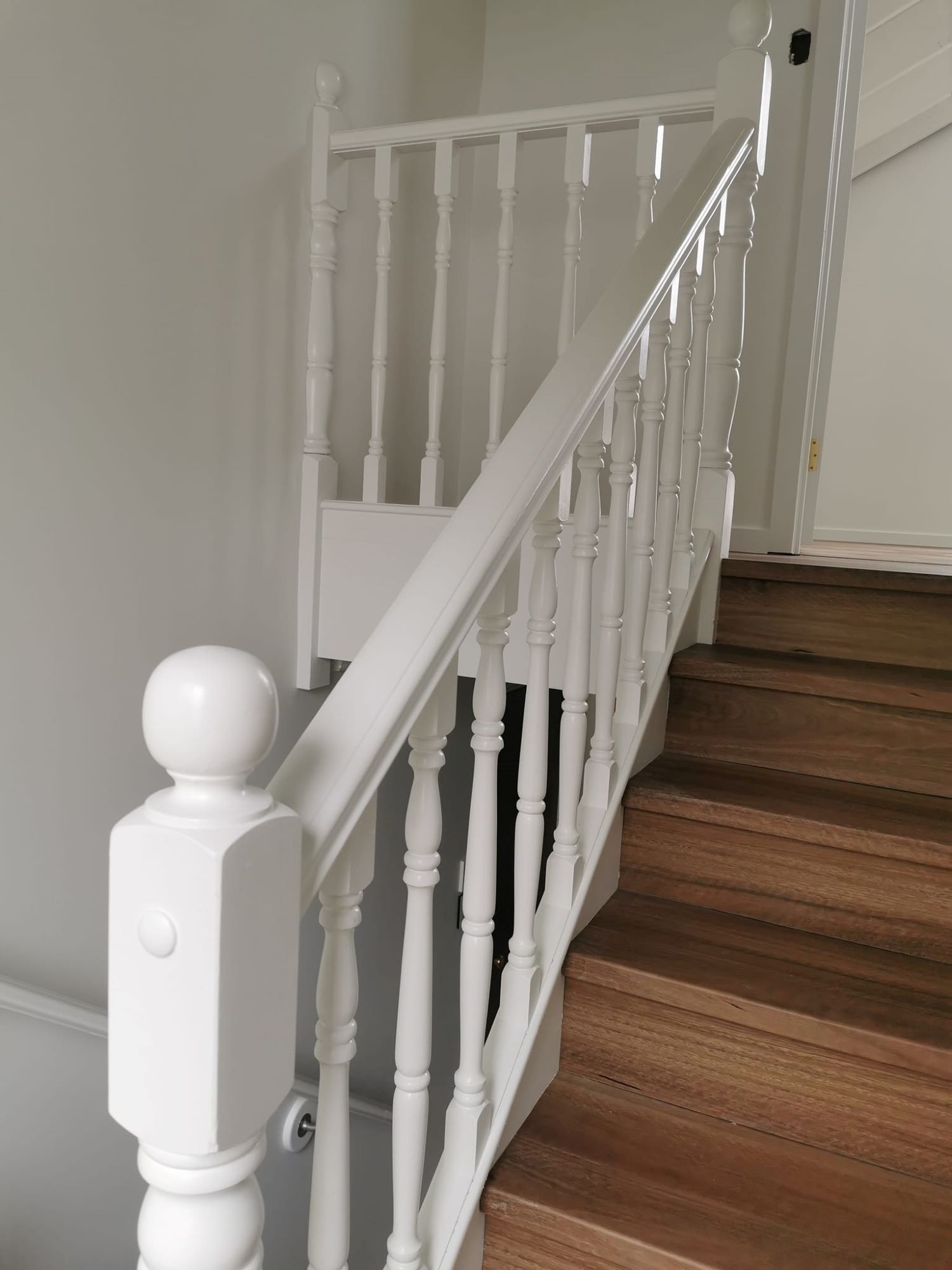 A White Railing on a Set of Wooden Stairs — Eva Professional Painting in Robina, QLD