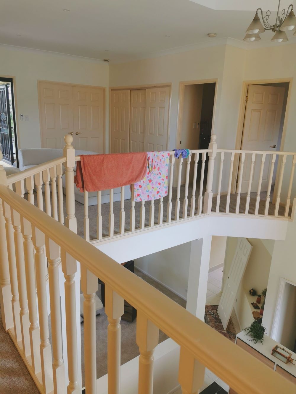 A Staircase in a House With a Wooden Railing — Eva Professional Painting in Helensvale, QLD