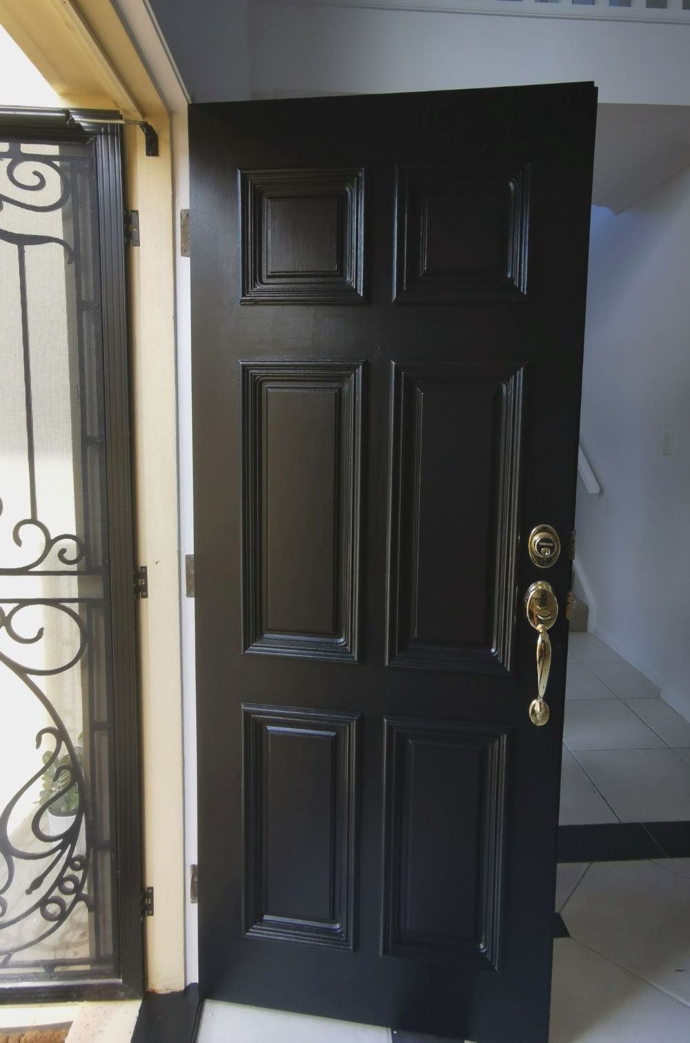 A Black Door With a Gold Handle — Eva Professional Painting in Robina, QLD