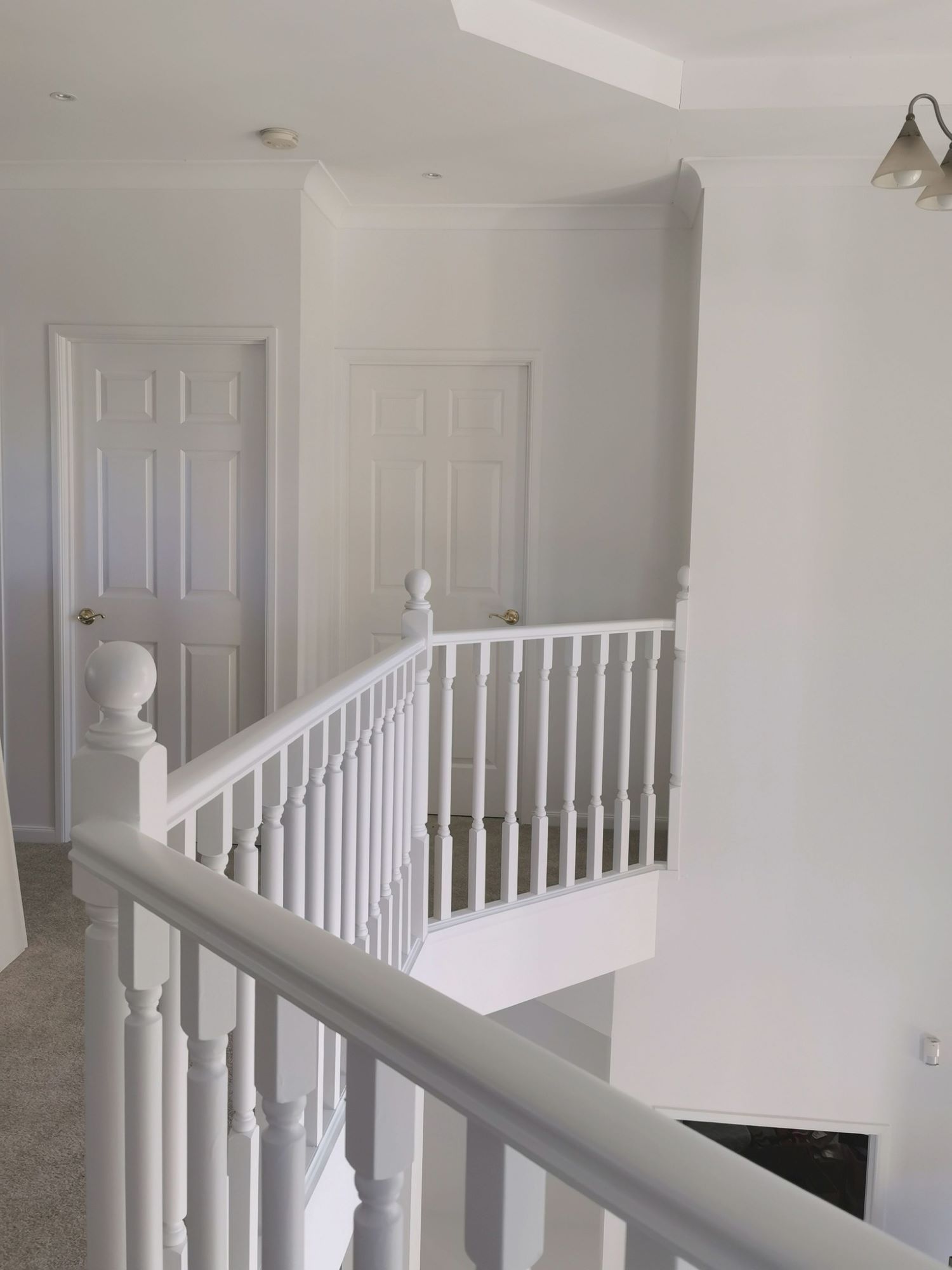A White Staircase With a White Railing and a White Door — Eva Professional Painting in Robina, QLD