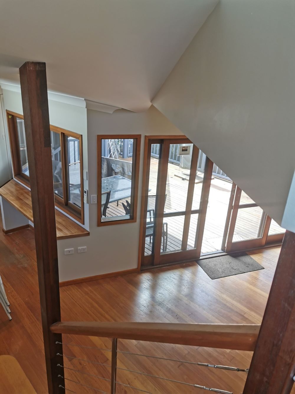 A View of a Living Room From the Top of a Staircase — Eva Professional Painting in Robina, QLD