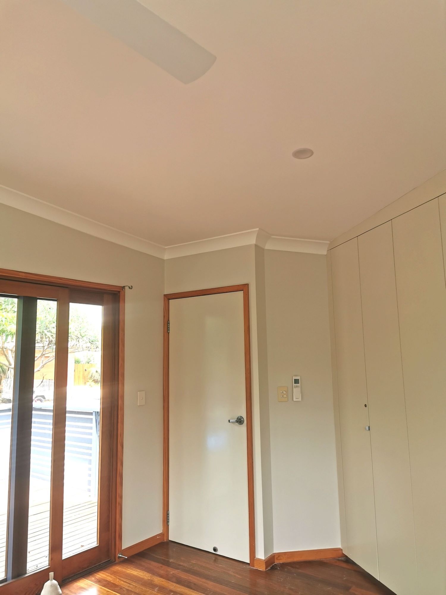 There is a Ceiling Fan in the Room With a Sliding Glass Door — Eva Professional Painting in Robina, QLD