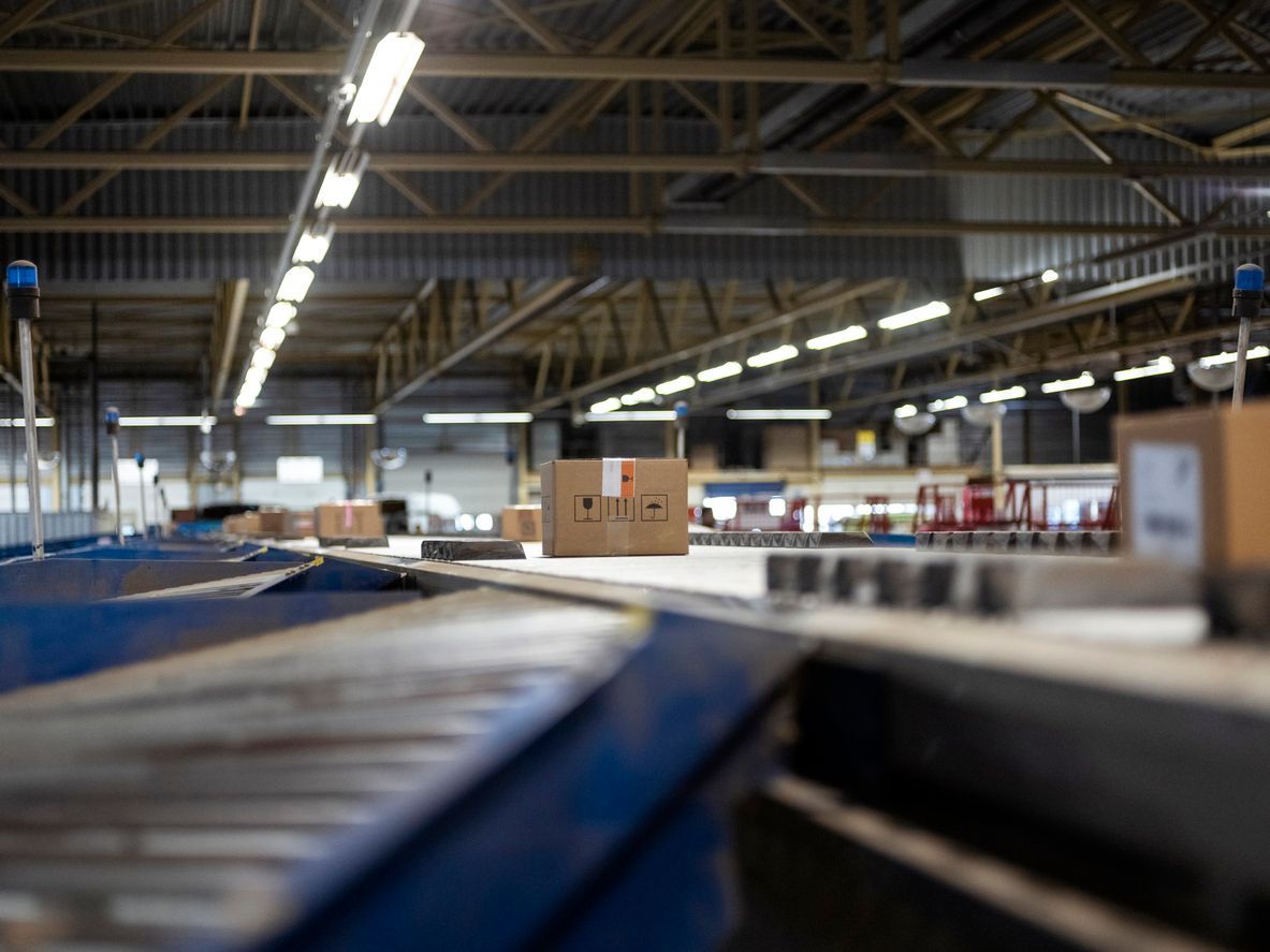 Industrial stainless steel processing equipment in a cleanroom environment. Pipes, tanks, and machinery are visible.