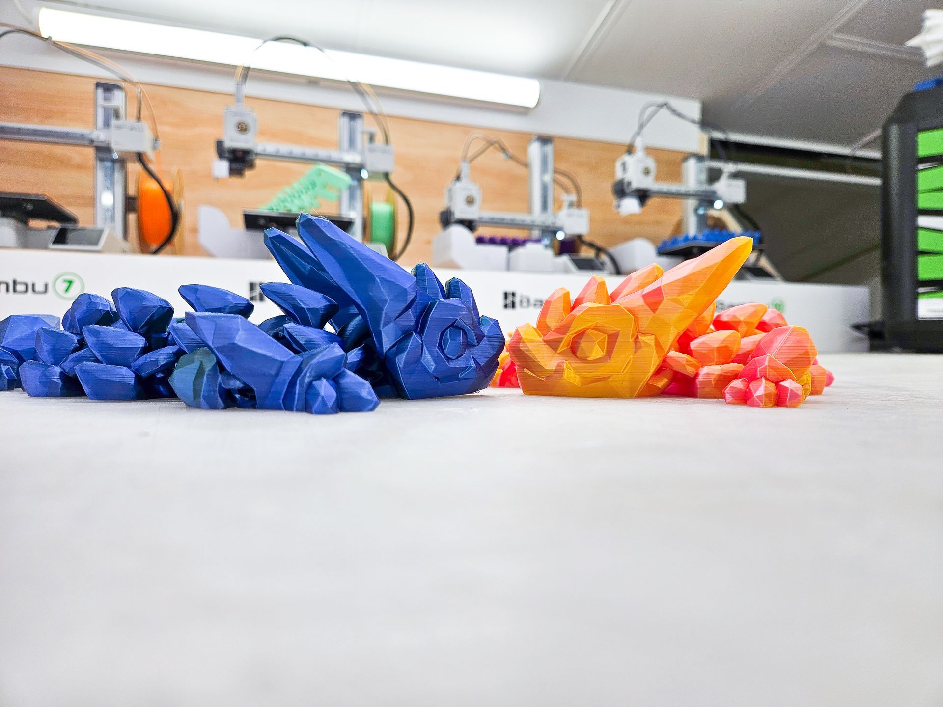 Three different colored crystals are stacked on top of each other on a white background.