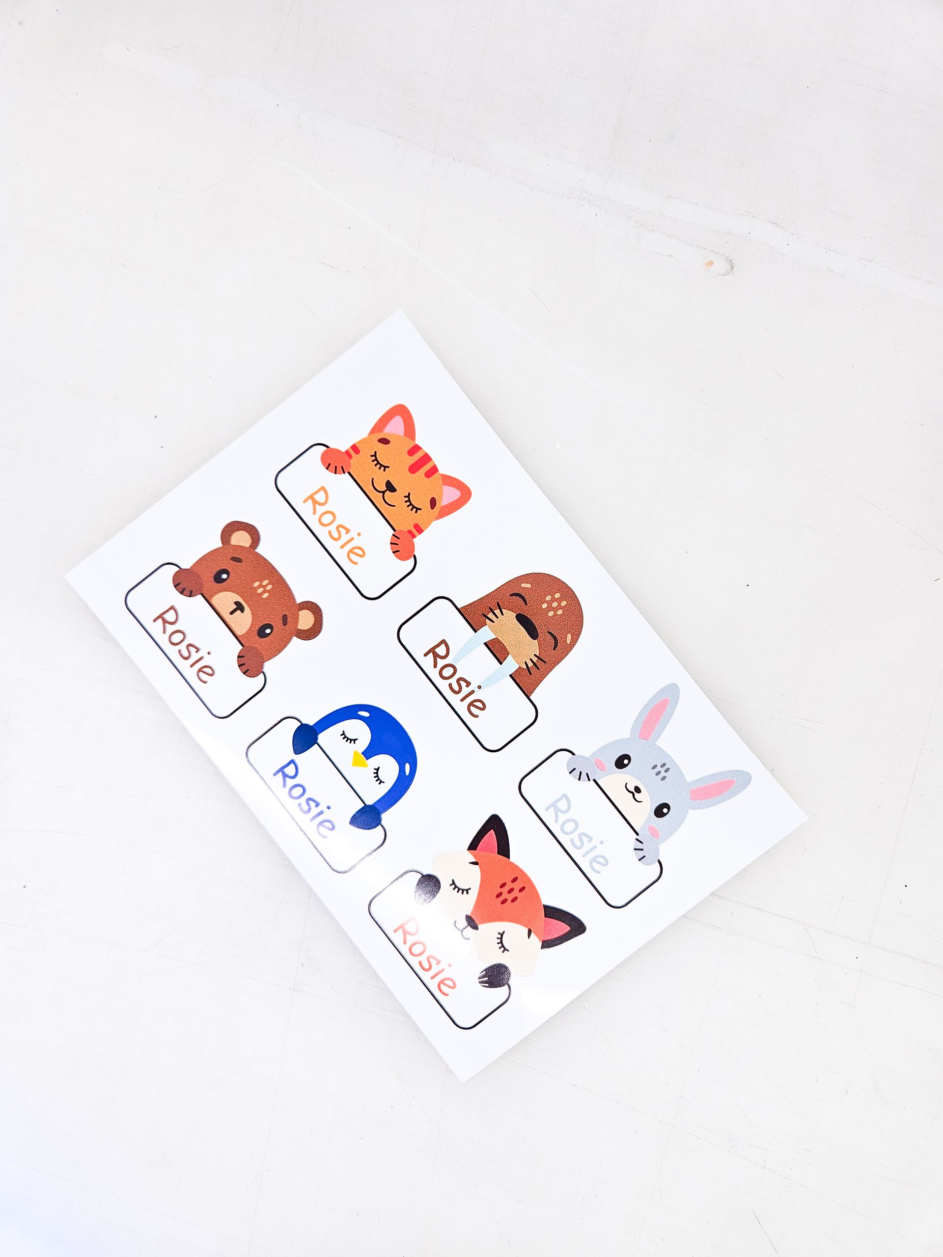 A set of name tags with animals and their names.