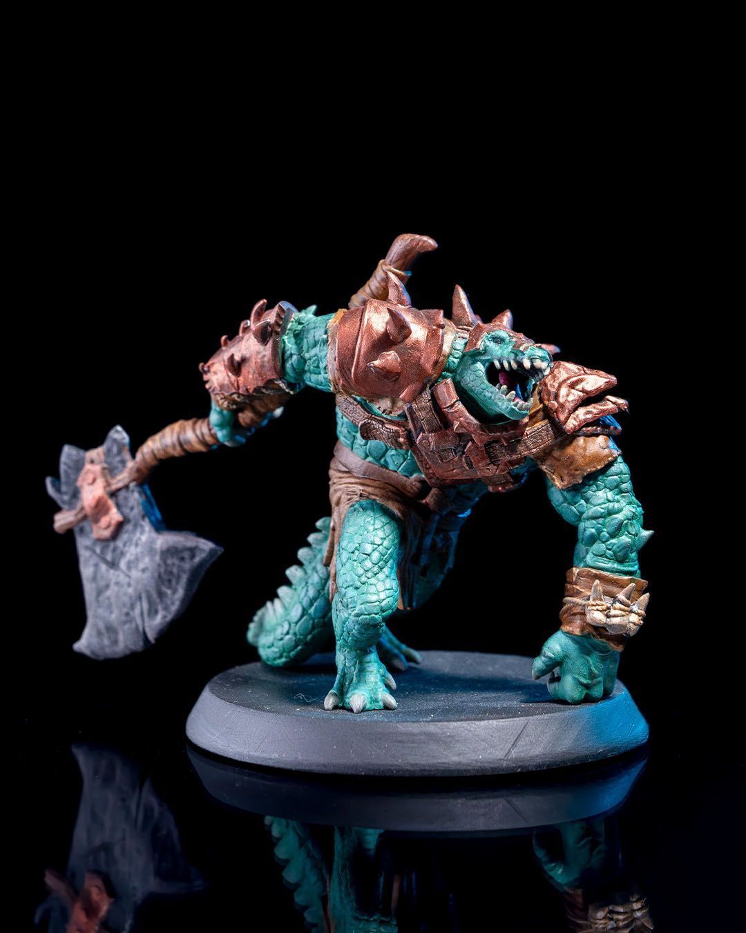 A statue of a monster with horns and chains on a white background.