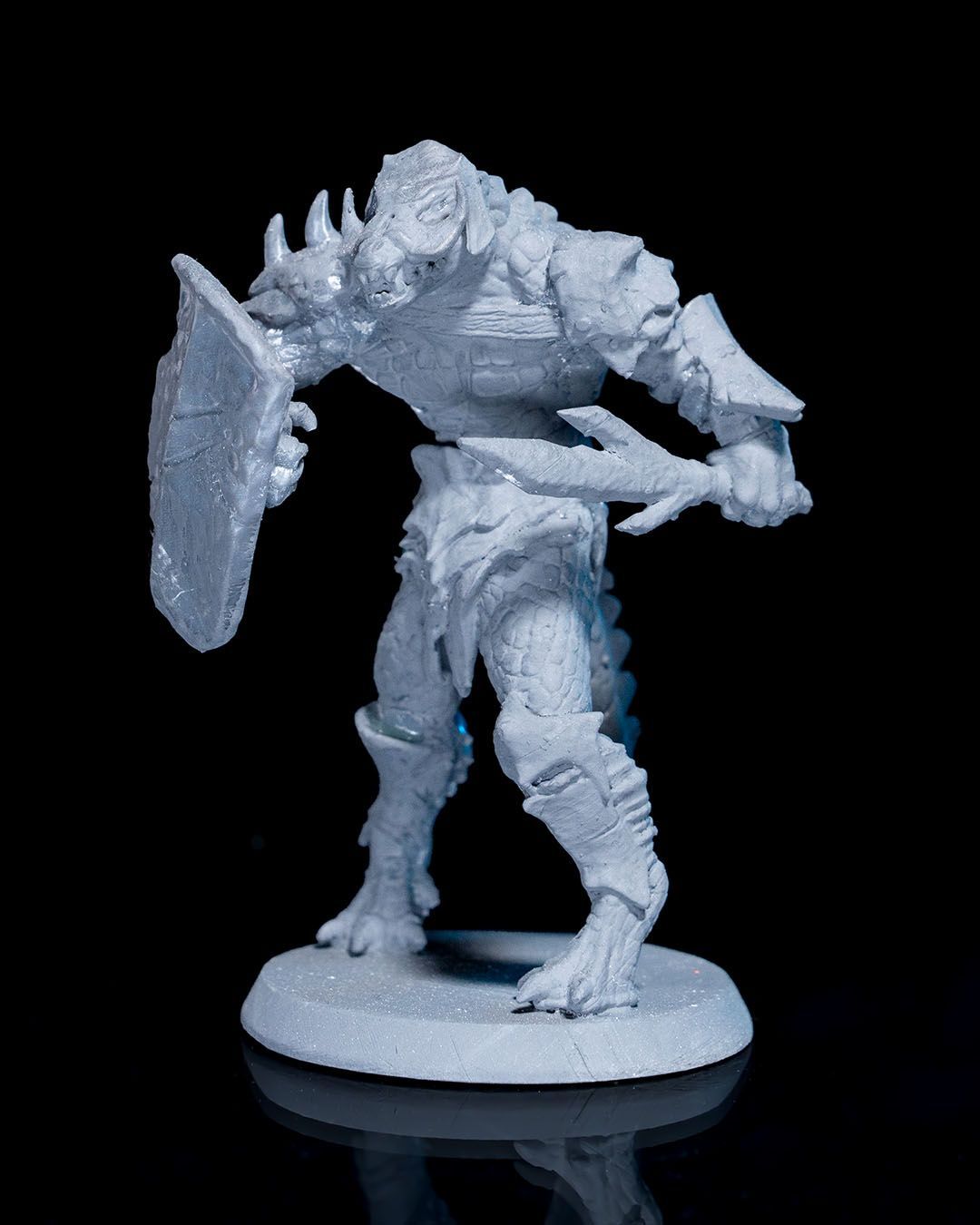 A statue of a dragon holding a shield.