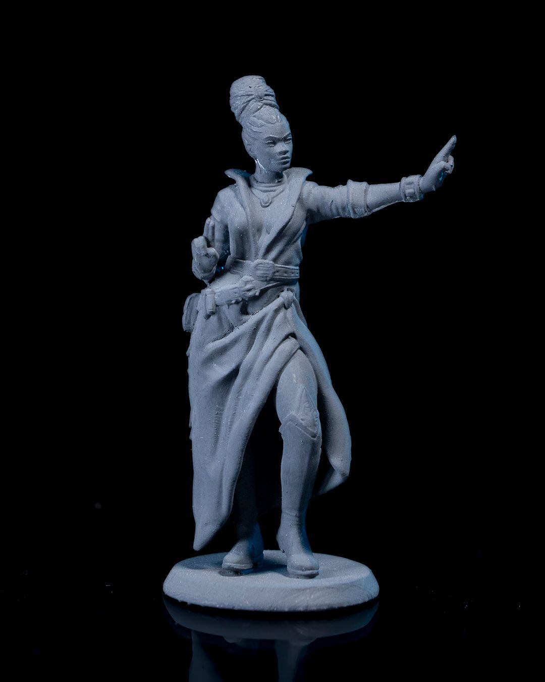 A statue of a woman standing with her arm outstretched.