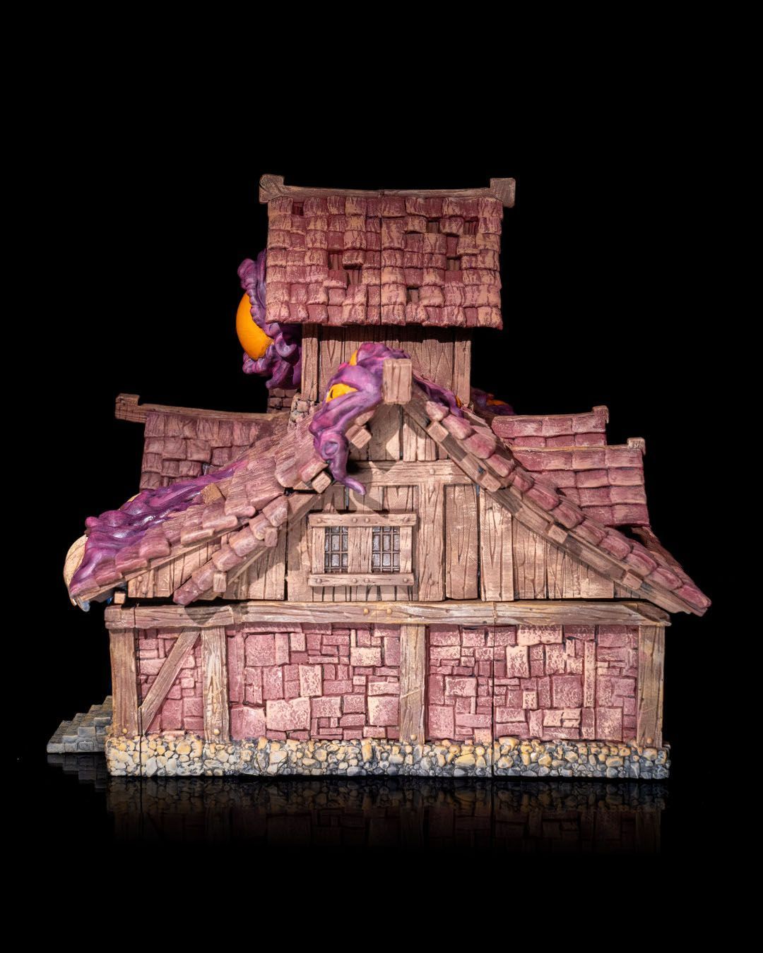 A purple house with a large eye on the top of it.