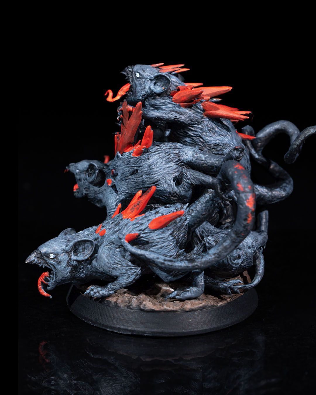 A statue of a bunch of rats on a white background.