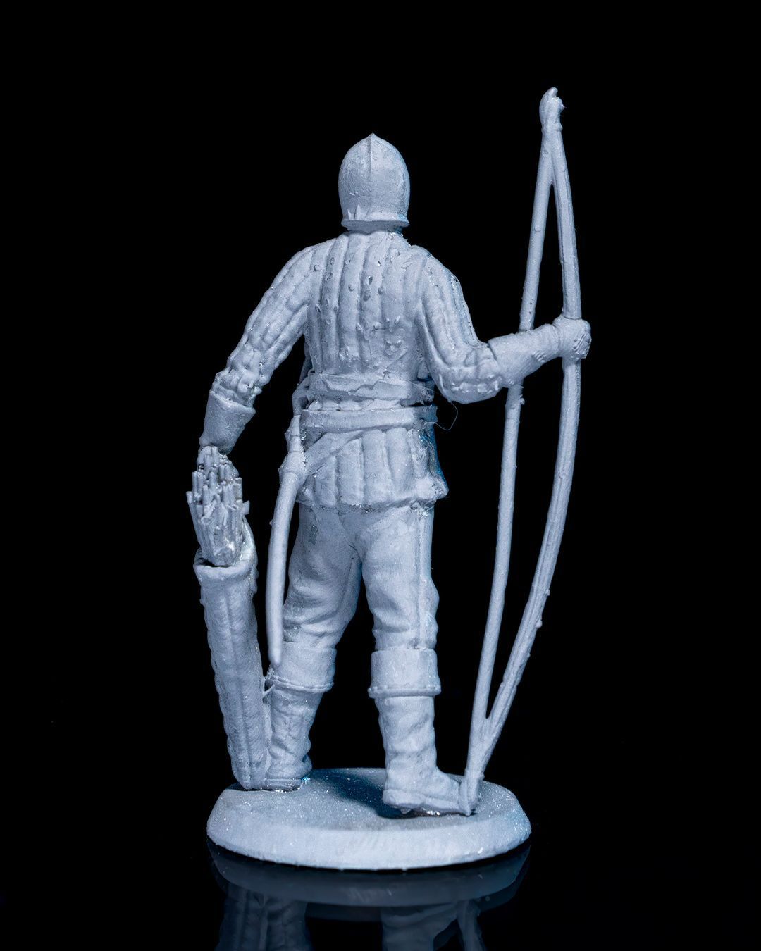 A statue of a man holding a bow and shield.
