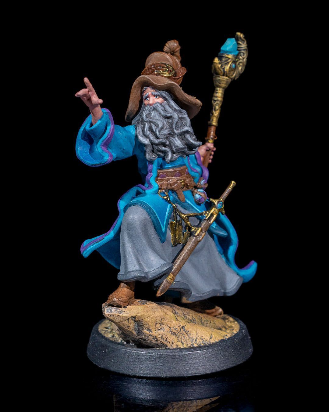 A statue of a wizard with a beard and a hat