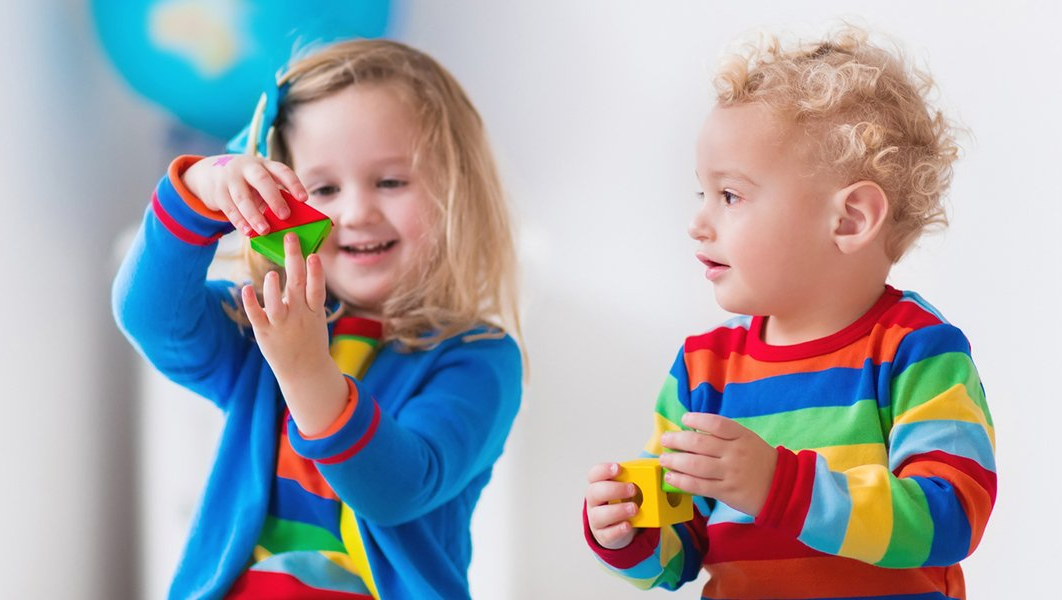 Childcare — Two Children Sitting on Ride on Toy in Playroom in Atlanta, GA