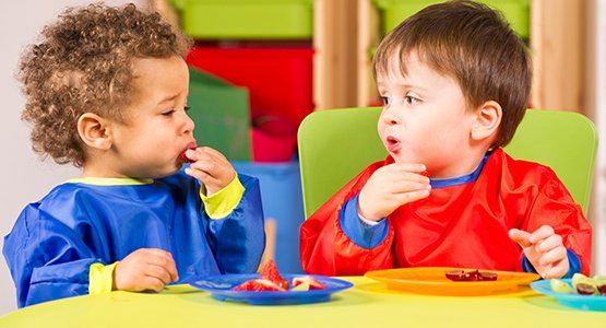 Early Childhood Education — Two Toddlers Eating Fruit in Atlanta, GA