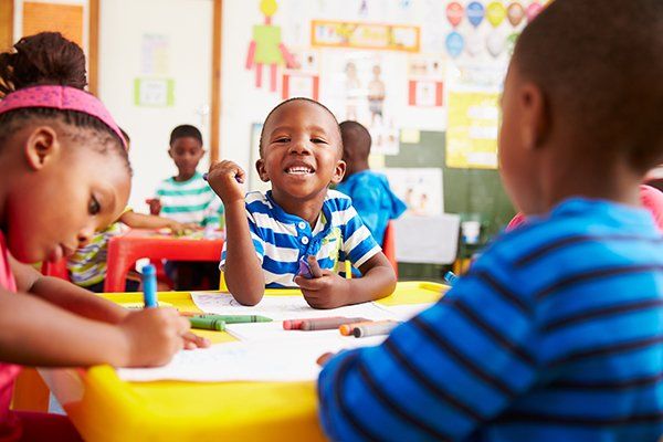 Childhood Education — Boy Smiling in Preschool Class in Atlanta, GA
