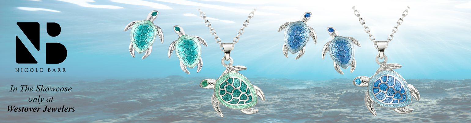 blue and green sea turtle necklaces and earrings on an oceanscape
