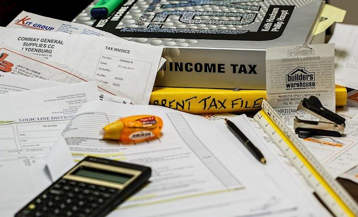 Tax books, documents, calculator and papers