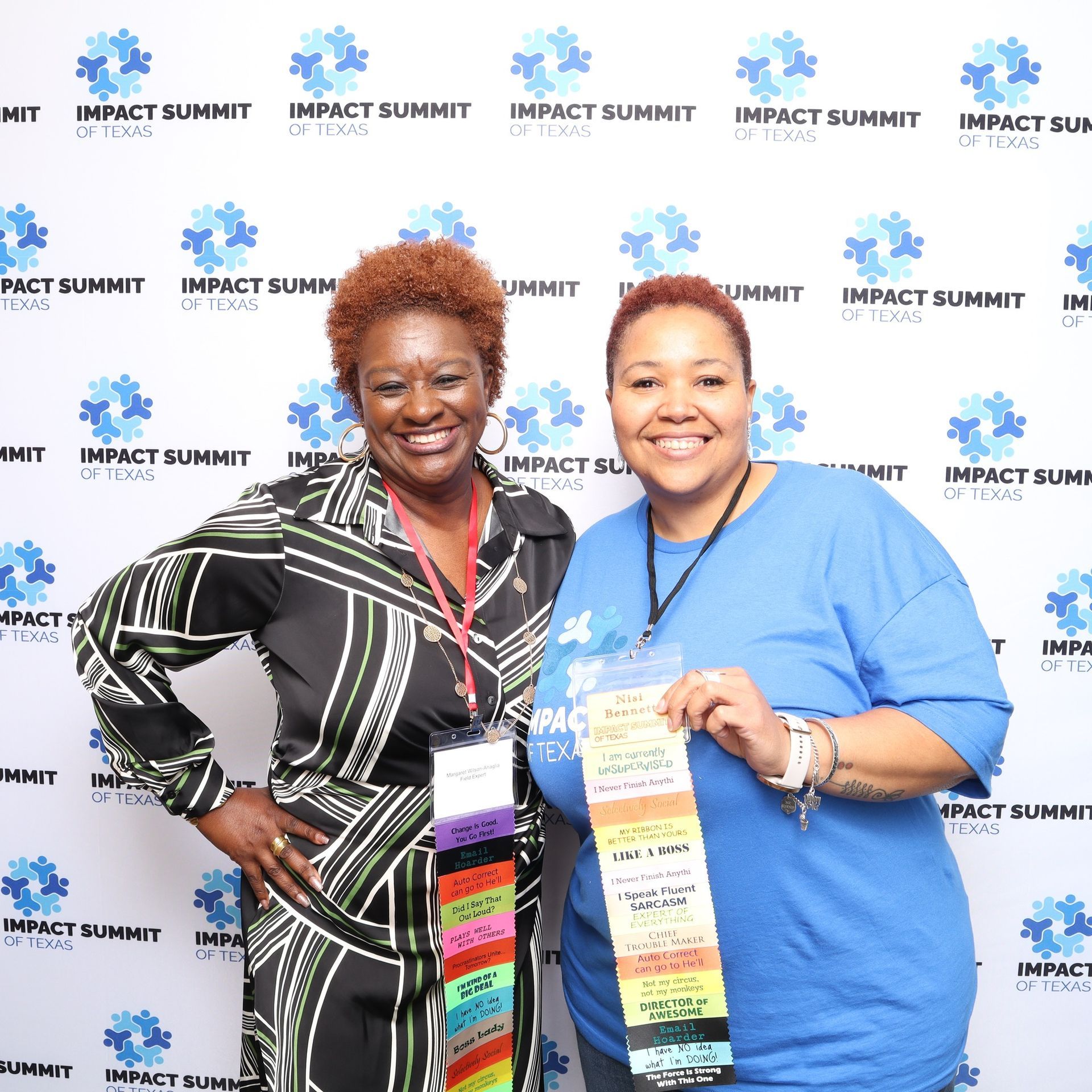 Two women standing in front of a wall that says impact summit