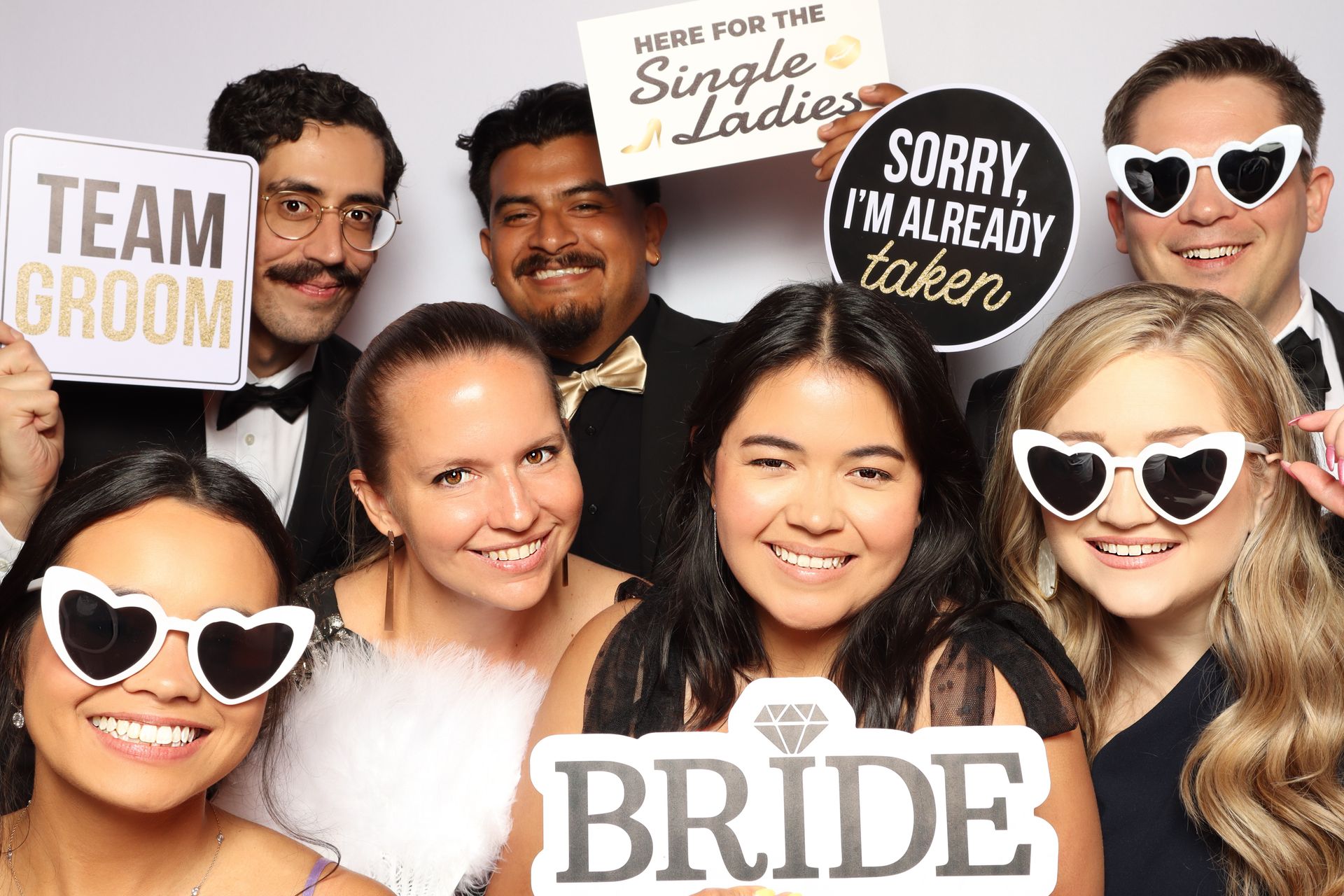 Wedding guests enjoying open-air photo booth during reception