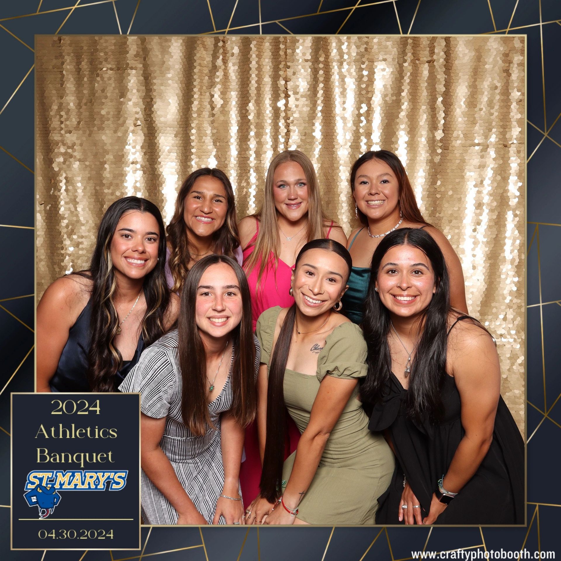 A group of women are posing for a picture in a photo booth.