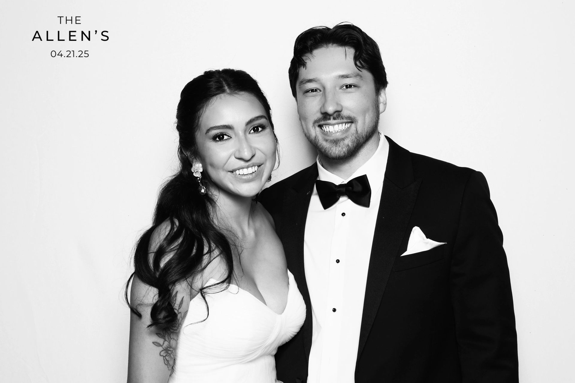 Bride and groom posing in luxury wedding photo booth experience