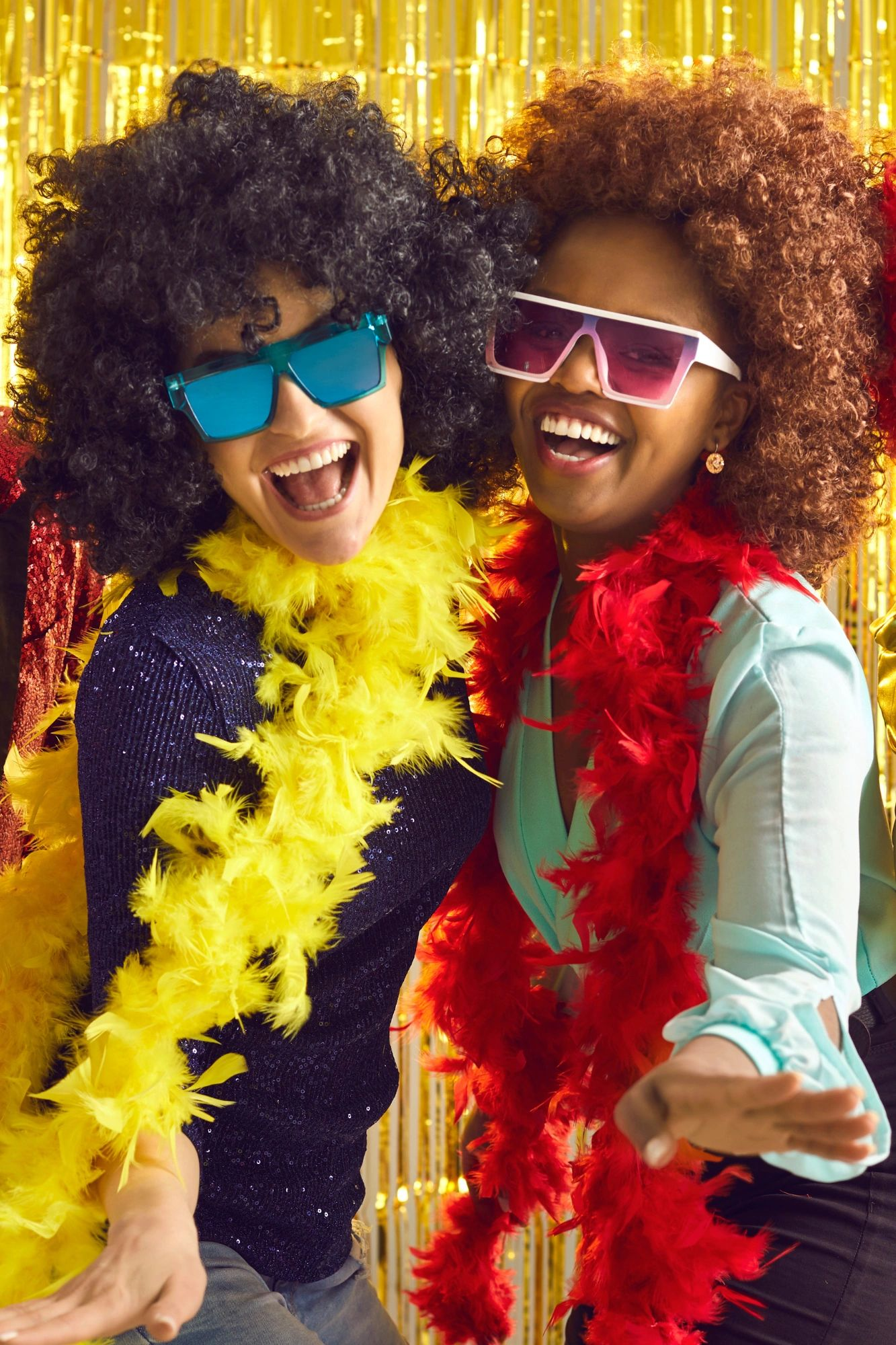 Two women wearing wigs and sunglasses are posing for a picture.