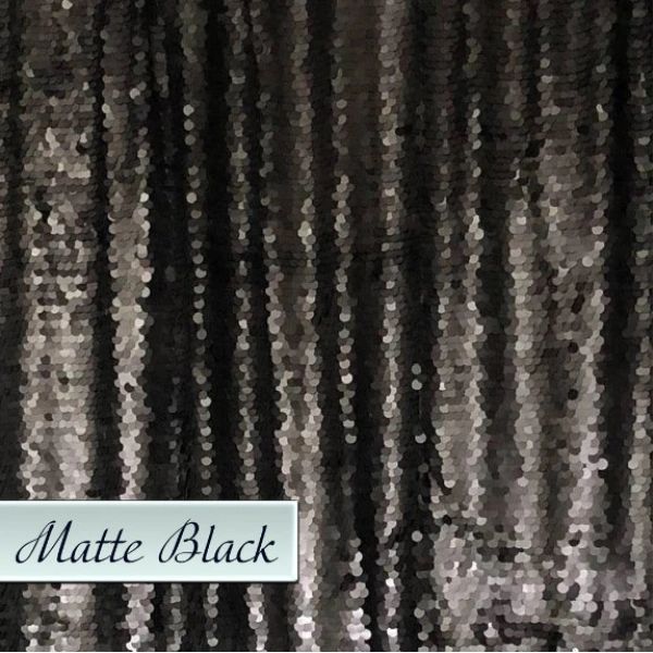 A close up of a black sequined curtain with a label that says matte black.