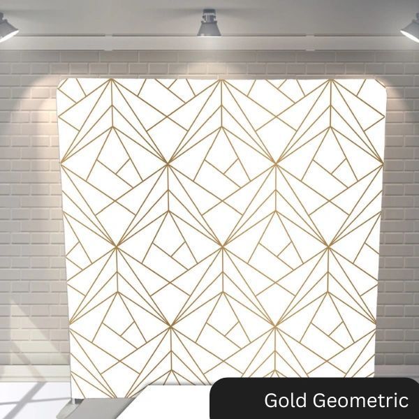 A white wall with a gold geometric pattern on it