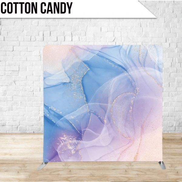 A cotton candy backdrop in front of a white brick wall