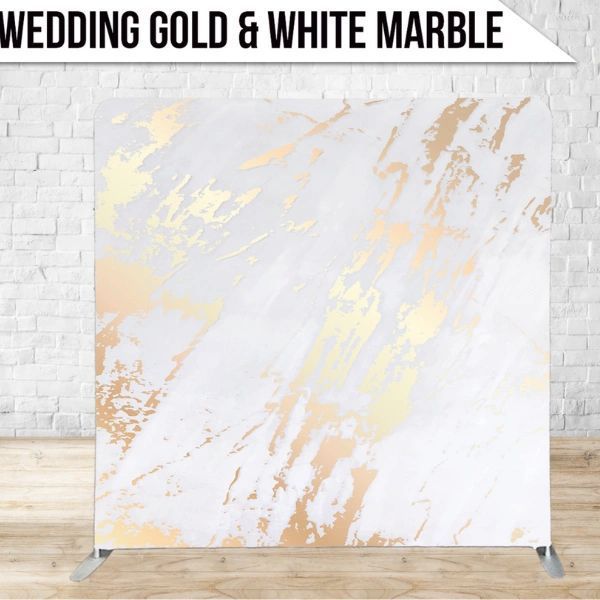 A wedding gold and white marble backdrop is sitting on a wooden floor