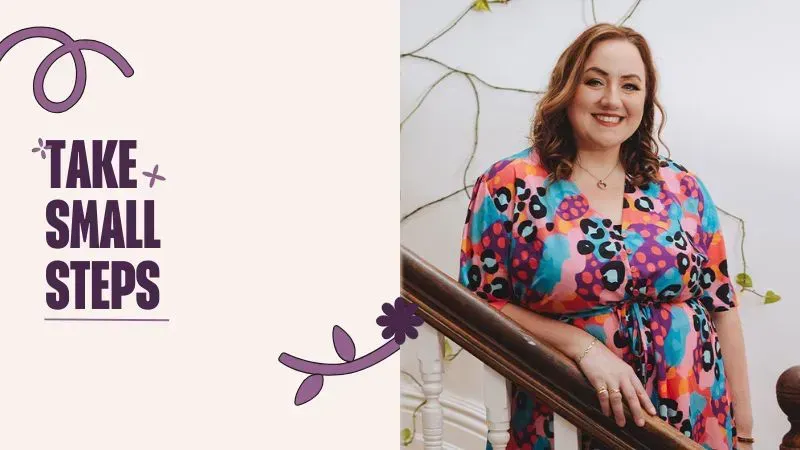 A woman in a floral dress is standing on a set of stairs.