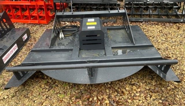 Black rotary mower attachment with a rounded front edge.