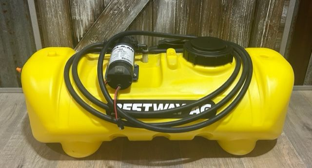 Yellow portable water tank with black pump, hose, and lid.