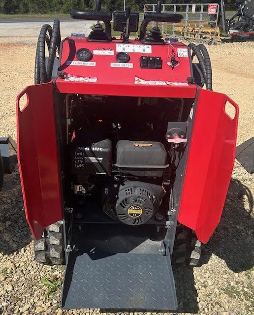 Red trenching machine with open panels, showing engine and controls.