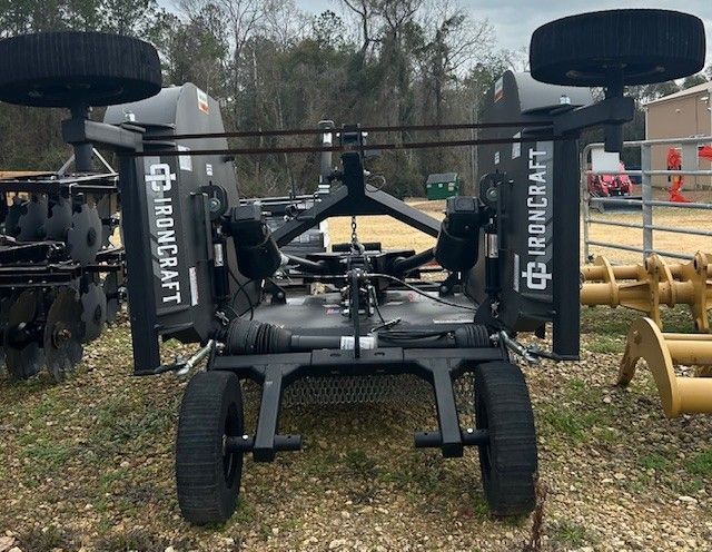 Black Ironcraft tractor attachment with two wheels and blades.