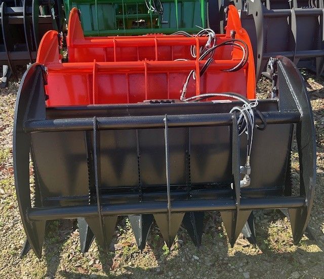 Three heavy-duty black and red grapple buckets for a tractor or other machinery.