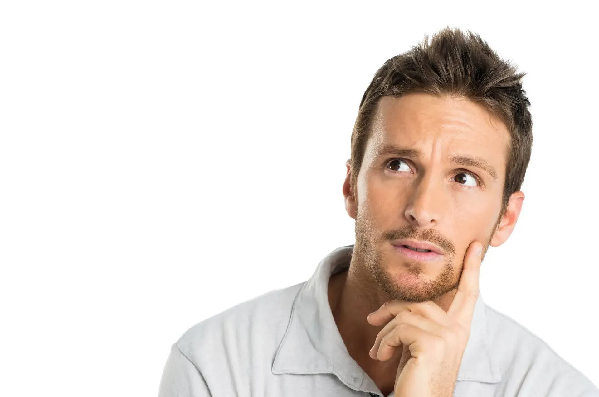 A man with a beard is thinking with his hand on his chin. A man with a beard is thinking with his hand on his chin.
