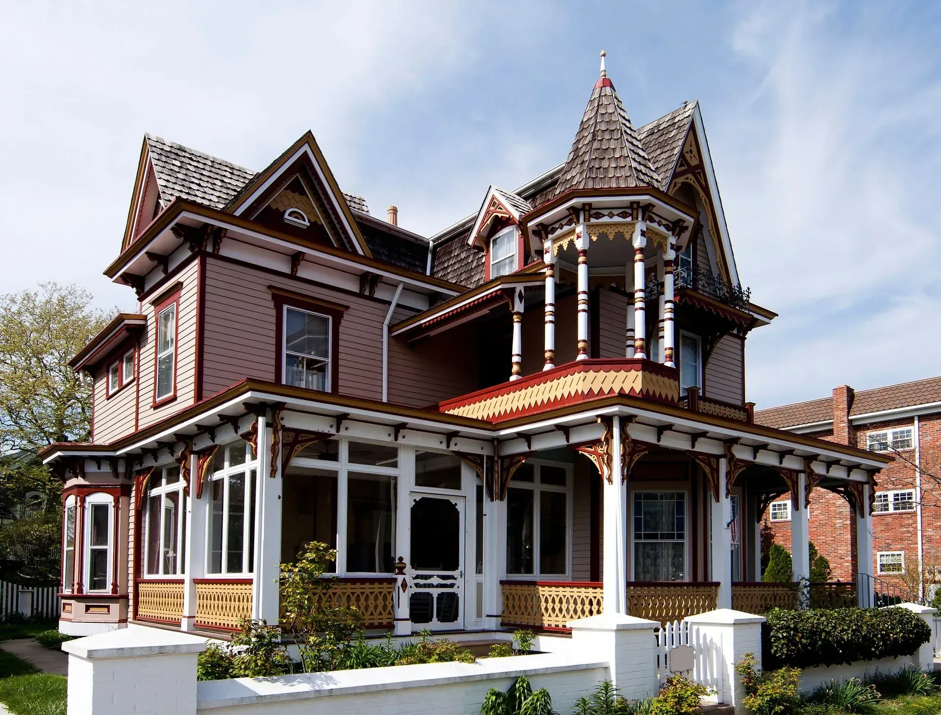 A large house with a large porch and a tower on top A large house with a large porch and a tower on top