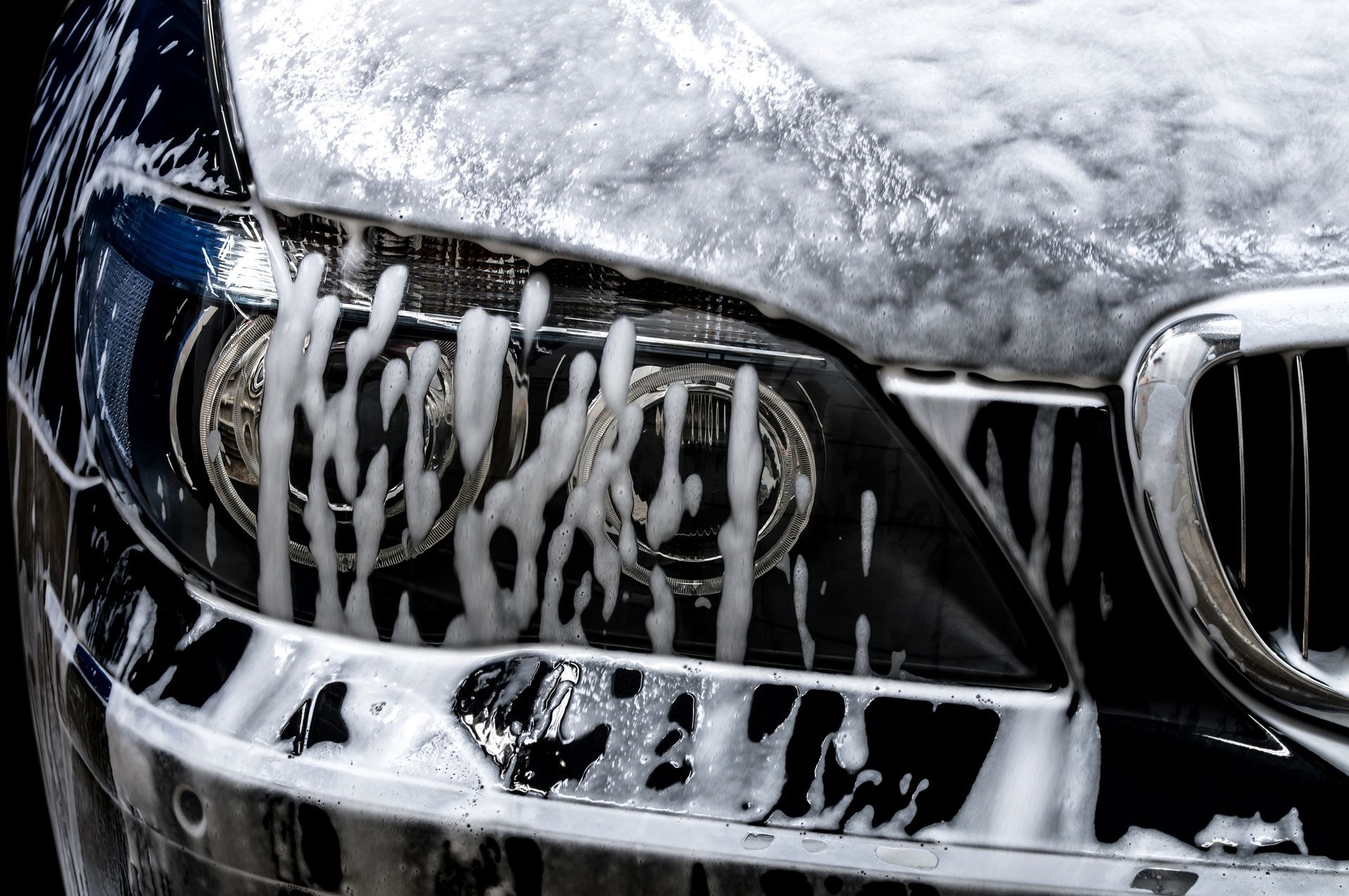 A car is being washed with soap and water.
