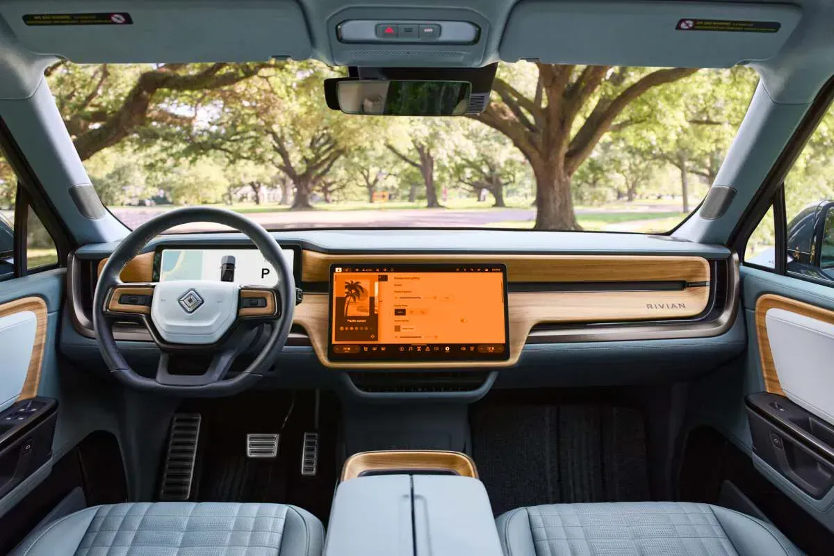 The interior of a car with a large screen on the dashboard.