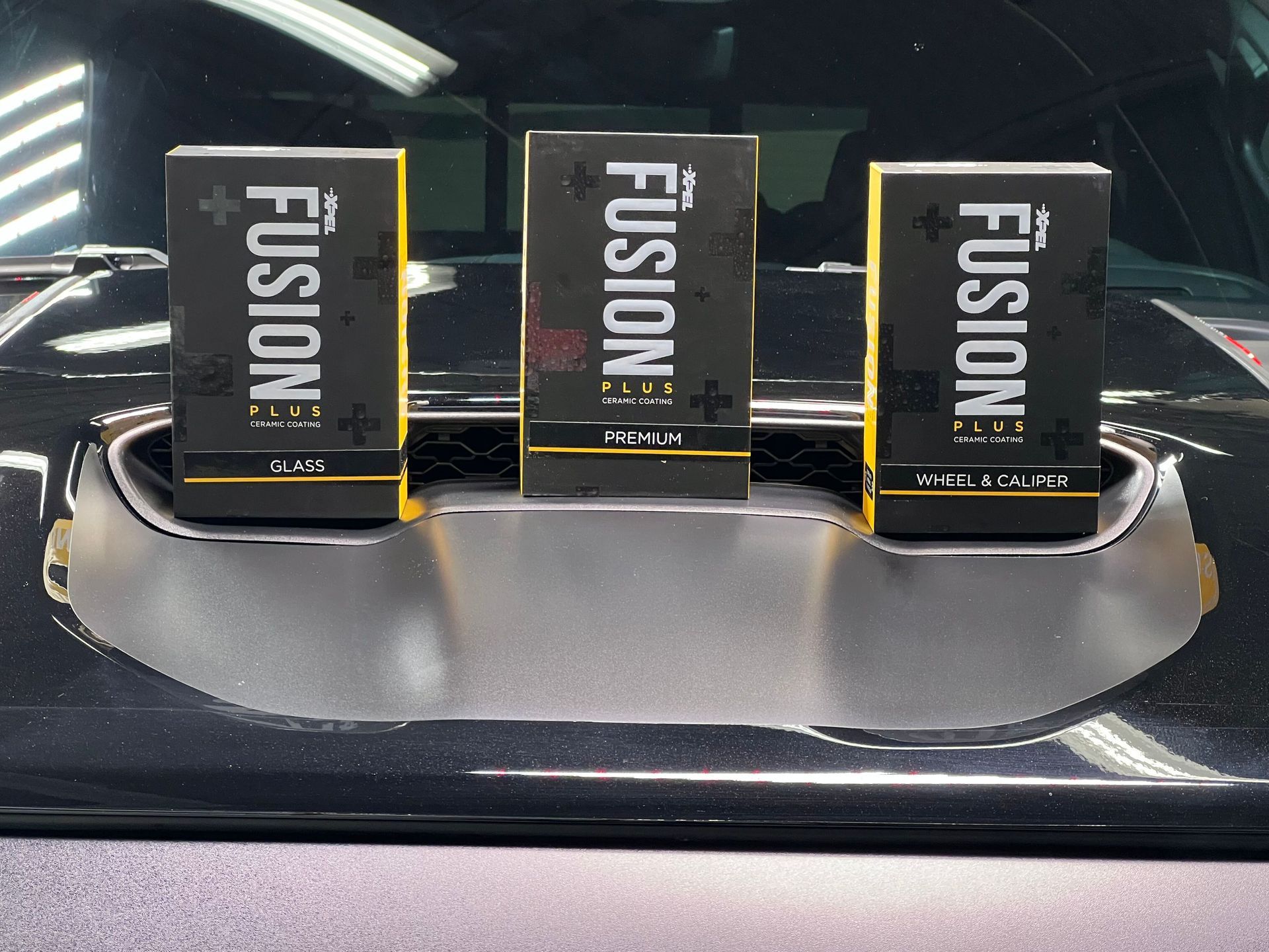 Three boxes of fusion sitting on top of a car
